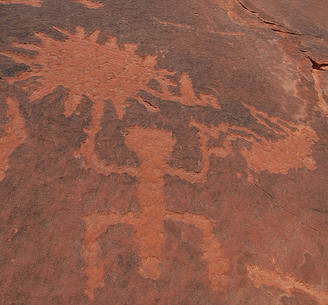 Kokopelli with birthing woman in association with the sun