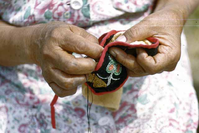 Mrs. Morgan Sewing Moccasin, Bena, 1948